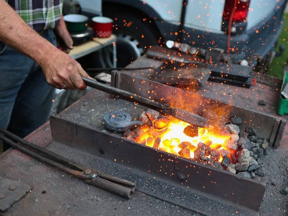 A blacksmithing demonstration with a glowing forge